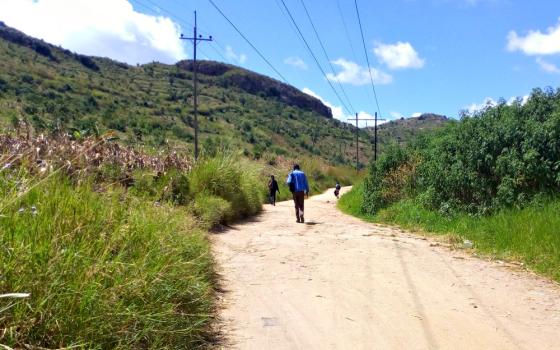 People walk along a road in Malawi April 13. (Wikimedia Commons/Matt Khofi)