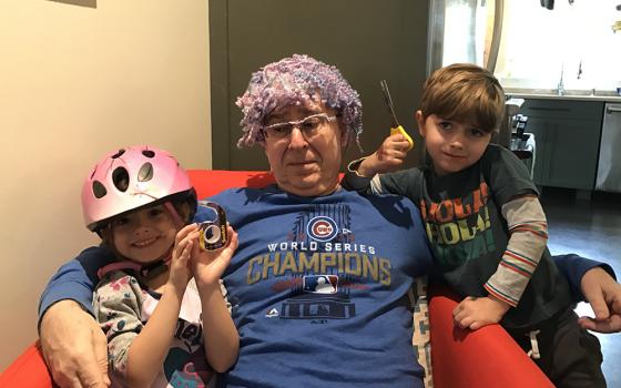 Grampa Michael Leach shows off the "hair transplant" created by his twin grandchildren, Mae and Jackson Leach. He wore it all the way back home on the plane from Atlanta to New York. (Courtesy of Jeff Leach)