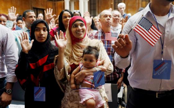 New citizens stand during the Pledge of Allegiance in July 2018 at the U.S. Citizenship and Immigration Services naturalization ceremony in the Manhattan section of New York City. (CNS/Reuters/Shannon Stapleton)