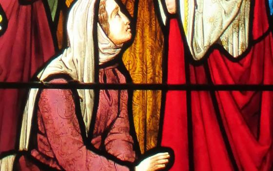 The woman touching Jesus' cloak, depicted in stained glass at St. Andrew's Church, Nuthurst, West Sussex, England (Wikimedia Commons/Antiquary)