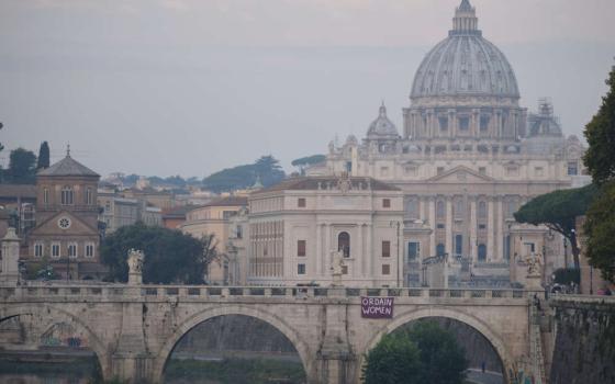 a purple banner reading "Ordain Women" was placed on the Sant'Angelo bridge