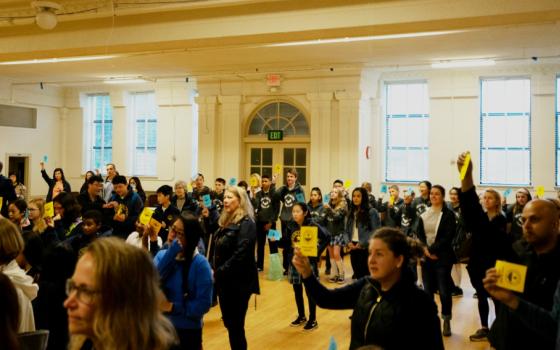 Parents and others gather April 4 at Star of the Sea School auditorium in San Francisco to show support for faculty members who have served the school, which will suspend classes at the end of the school year. (Courtesy of anonymous parent)