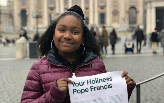 At the Vatican on Feb. 19, Genesis Butler shows the letter she wrote to Pope Francis asking him to adopt a vegan lifestyle during Lent. (Courtesy of Million Dollar Vegan)