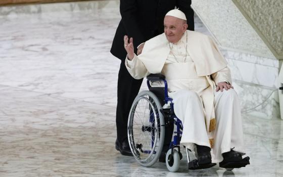 Pope Francis arrives in a wheelchair to attend an audience with nuns and religious superiors in the Paul VI Hall at the Vatican May 5. (AP file/Alessandra Tarantino)