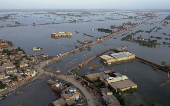 Homes are surrounded by floodwaters in Sohbat Pur city, a district of Pakistan’s southwestern Balochistan province, Aug. 29, 2022. (AP Photo/Zahid Hussain)