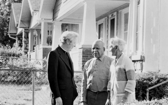 In 1977, Fr. Norm Rotert talks with Robert and Delia Harris, who were living in a home they got through the Blue Hills Homes Corporation, founded by Rotert in Kansas City, Missouri. (NCR photo/Bob Hart)