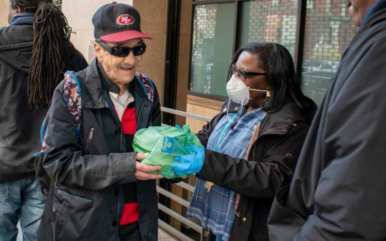 Volunteers hand out meals to homeless people in the community at St. Anthony's in San Francisco's Tenderloin district. (Provided photo)