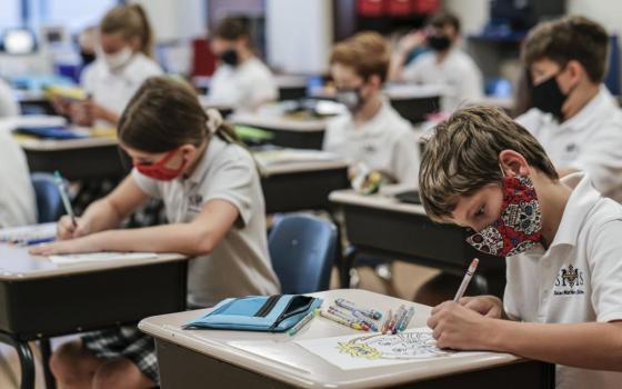 Students work at their desks on the first day of the new school year at St. Matthew School in Franklin, Tenn., Aug. 6, 2020, with extensive COVID-19 protocols in place, including temperature screening and mandatory face masks for each student. (CNS photo/