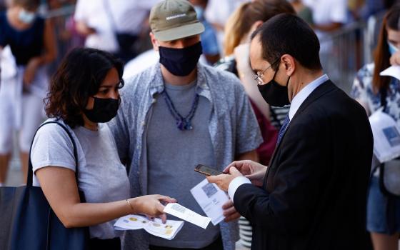 People have their "green pass," signifying vaccination against COVID-19 or a negative test taken within 48 hours, checked before entering the Vatican Museums at the Vatican in this Aug. 6, 2021, file photo.