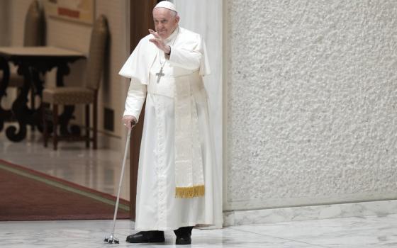 Pope Francis waves to faithful as he arrives in the Paul VI hall for his the weekly general audience at the Vatican, Wednesday, Aug. 10, 2022. (AP Photo/Andrew Medichini)