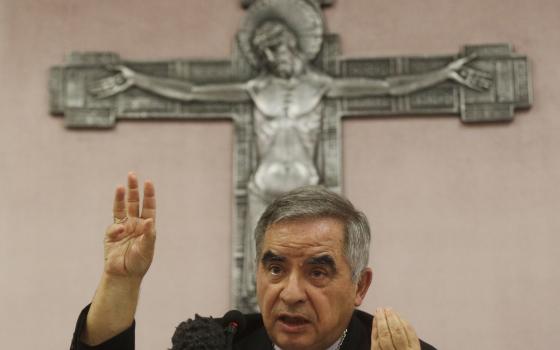 Cardinal Angelo Becciu talks to journalists during a press conference in Rome. Sept. 25, 2020 (AP Photo/Gregorio Borgia, File)