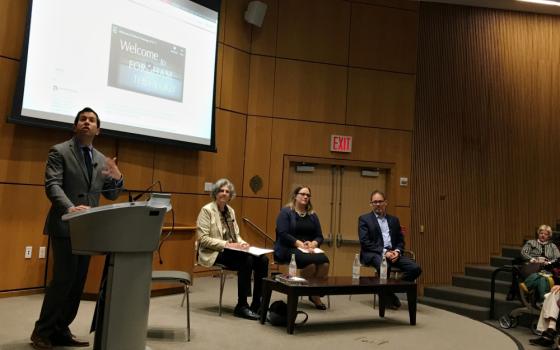 J. Patrick Hornbeck II, chair of the Theology Department at Fordham University, introduces (from left) Phyllis Zagano, Meghan Clark and George Demacopoulos, panelists for the symposium on women deacons Oct. 22 in New York. (NCR photo/Sarah Salvadore)