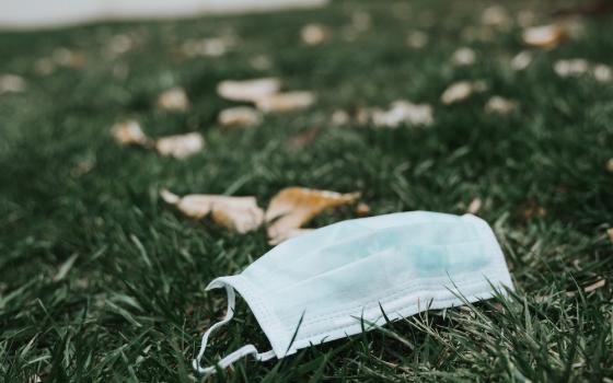 Discarded face mask on lying on the grass