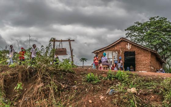 People outside a Catholic church in a village in Malanje Province, Angola, in 2018 (Dreamstime/Nuno Almedia)