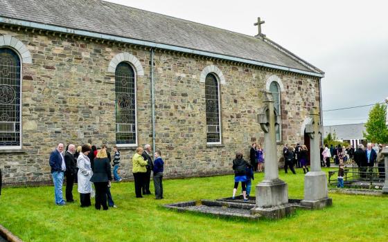 People chat after Mass outside a parish church in a small village in Ireland. (Dreamstime/Imagoinsulae)