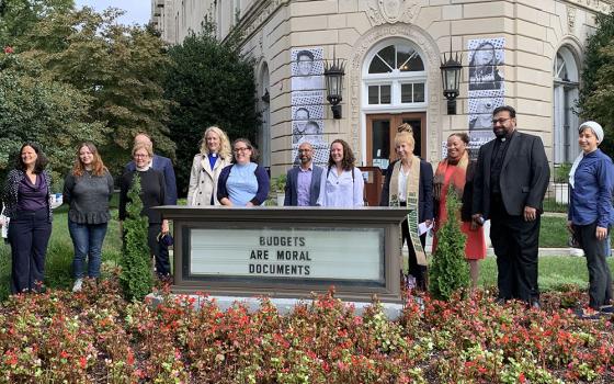 Faith leaders and staff gather in prayer and reflection Sept. 23 in front of the United Methodist Building in Washington to call on lawmakers to push for the $3.5 trillion human infrastructure bill. (NCR/Melissa Cedillo)