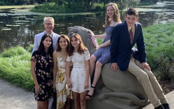 Masks in hand, Dr. Jennifer Avegno, front row, second from left, and her family pose together in September: husband Kurt Weigle and children, from left, Lucy, 15, Gigi, 11, Eva, 14, and Joey, 17 (Provided photo)