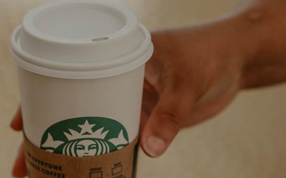 Starbucks coffee cup (Unsplash/Kadarius Seegars)