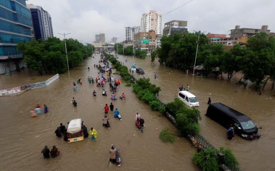 Climate change increases the likelihood of extreme weather, like the rains that caused this flooding in Karachi, Pakistan, in late August 2020. (CNS photo/Akhtar Soomro, Reuters)