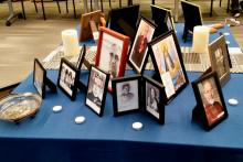 An ofrenda set up at the 2019 ACHTUS Colloquium at the University of Dayton, Ohio, June 2-5 displays photos of deceased ACHTUS members, loved ones and others. (NCR photo/Maria Benevento)