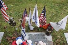 Flags and other items surround the grave where Franciscan Father Mychal F. Judge, a chaplain of the New York Fire Department, is buried at Holy Sepulchre Cemetery in Totowa, New Jersey.  Judge died in the Sept. 11, 2001, World Trade Center attacks. (CNS/O