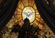 The Holy Spirit window is pictured through the Baldacchino in St. Peter's Basilica at the Vatican. (CNS/Paul Haring)