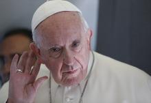 Pope Francis listens to a question while responding to journalists aboard his flight from Tallinn, Estonia, to Rome in this Sept. 25, 2018, file photo. (CNS/Paul Haring)