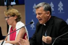 Secretary General of the Synod of Bishops Cardinal Mario Grech, right, delivers his speech during a presentation of the new guidelines for the Synod of Bishops at the Vatican June 20. At left is Helena Jeppesen Spuhler, a synod participant from Switzerland who was among those presenting the document. (AP/Domenico Stinellis)