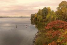 A lake with two paddleboarders (Unsplash/Alex Guillaume)