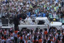 People react as Pope Francis arrives at Madya Stadium in Jakarta, Indonesia, Thursday, Sept. 5, 2024. (AP Photo/Tatan Syuflana)