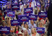 Delegates holds "Mass deportation now!" signs on Day 3 of the Republican National Convention at the Fiserv Forum in Milwaukee on July 17. (OSV News/Reuters/Brian Snyder)