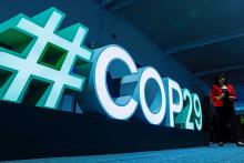 A woman passes by a #COP29 sign during the U.N. climate change conference COP29 in Baku, Azerbaijan, Nov. 11, 2024. (OSV News/Reuters/Maxim Shemetov)