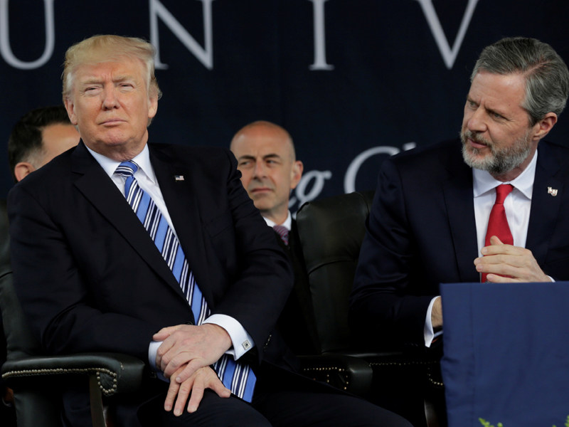 President Trump, left, sits before delivering the keynote address at Liberty University’s commencement in Lynchburg, Va., on May 13, 2017. Seated on the right is Liberty University President Jerry Falwell Jr. (Yuri Gripas/Reuters)