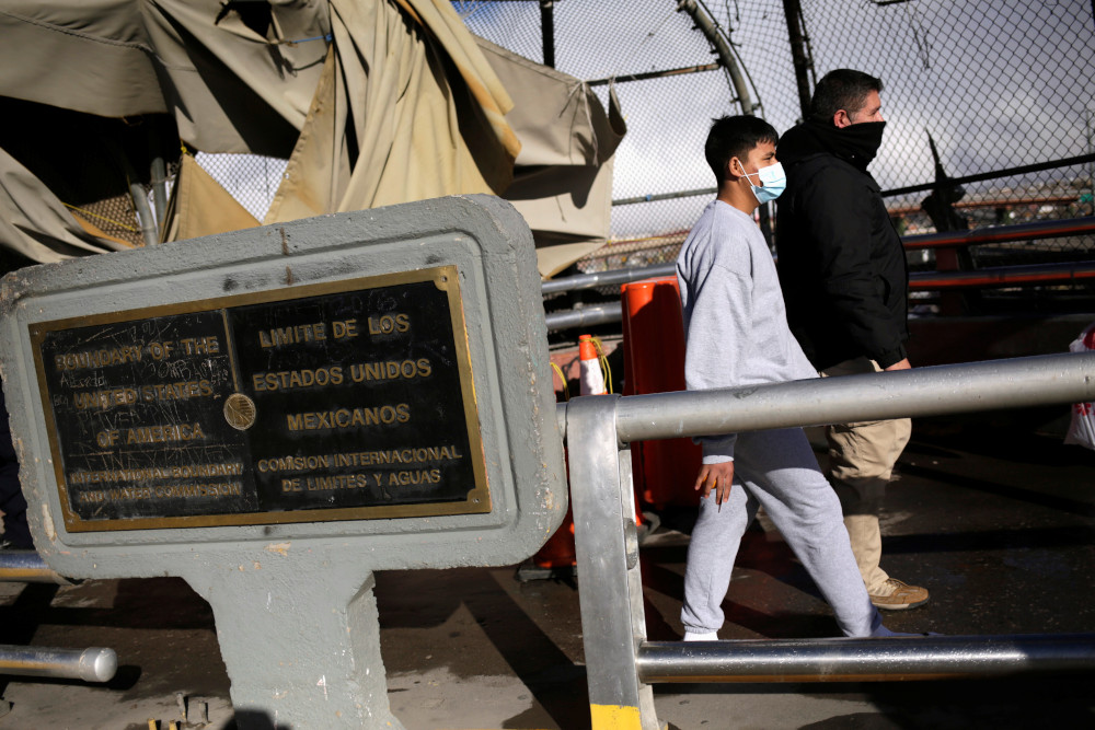 A migrant is deported from the U.S., and into Ciudad Juarez, Mexico, through the Paso del Norte international border bridge Jan. 26. (CNS/Reuters/Jose Luis Gonzalez)