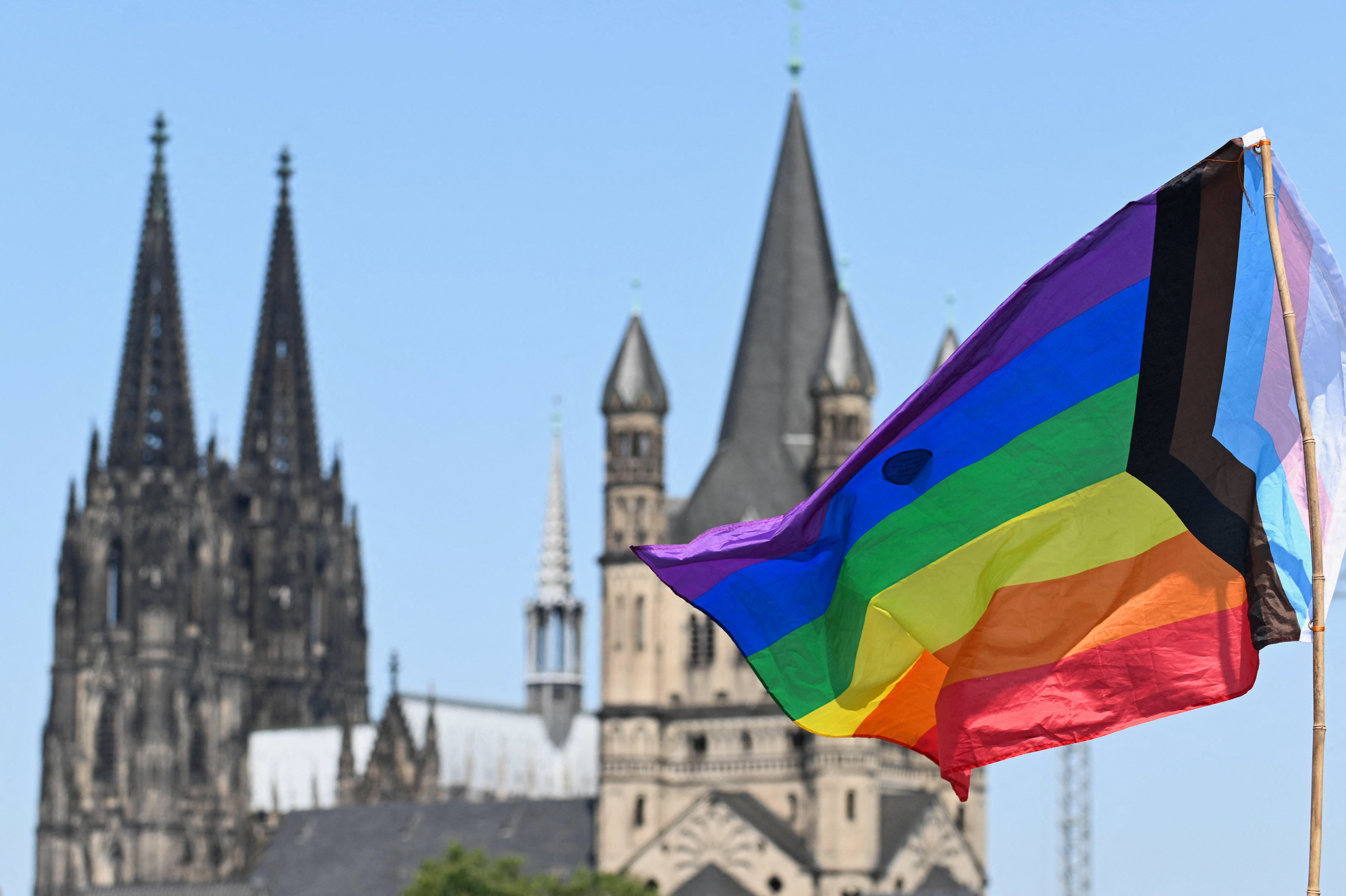 A rainbow flag is seen near the spires of the Cologne Cathedral on July 9, 2023. (OSV News photo/Jana Rodenbusch, Reuters)
