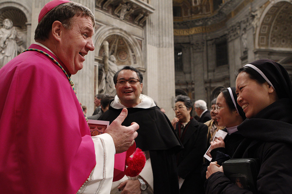 Archbishop Joseph Tobin, then secretary of the Vatican's Congregation for Institutes of Consecrated Life and Societies of Apostolic Life, talks with religious after Pope Benedict XVI's vespers with members of religious orders in St. Peter's Basilica at the Vatican Feb. 2, 2011. (CNS/Paul Haring)