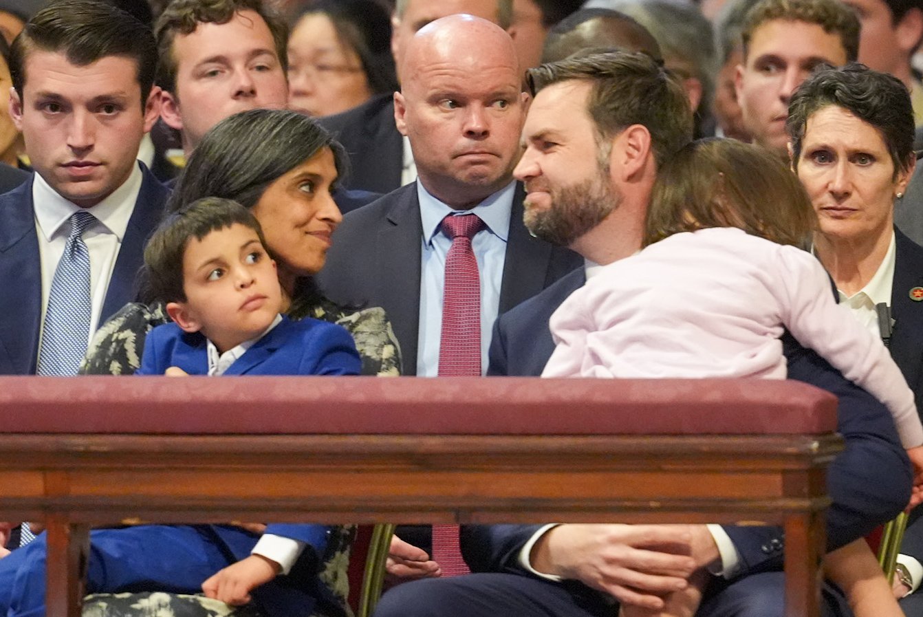 U.S. Vice President JD Vance, holding their daughter, smiles with his wife, Usha, who is holding their son, before the start of the Liturgy of the Lord's Passion in St. Peter's Basilica at the Vatican April 18, 2025. (CNS photo/Lola Gomez)