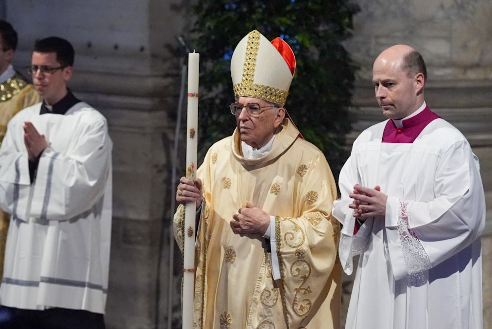 Cardinal Giovanni Battista Re, dean of the College of Cardinals, processes into St. Peter's Basilica at the beginning of the Easter Vigil Mass at the Vatican April 19, 2025. (CNS photo/Lola Gomez)