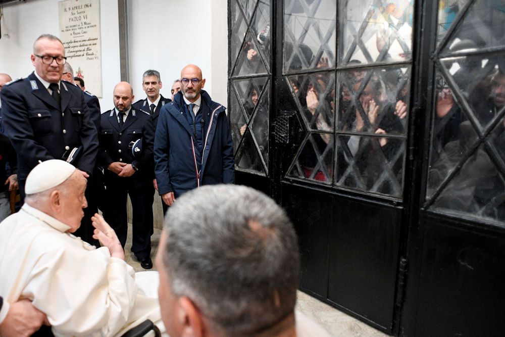 Pope Francis blows a kiss to inmates unable to meet him personally during a Holy Thursday visit to Rome's Regina Coeli jail April 17. 