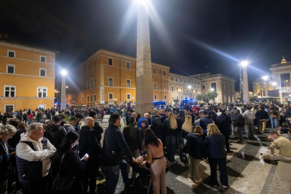 People stand in line outside the Vatican to pay their respects to Pope Francis.