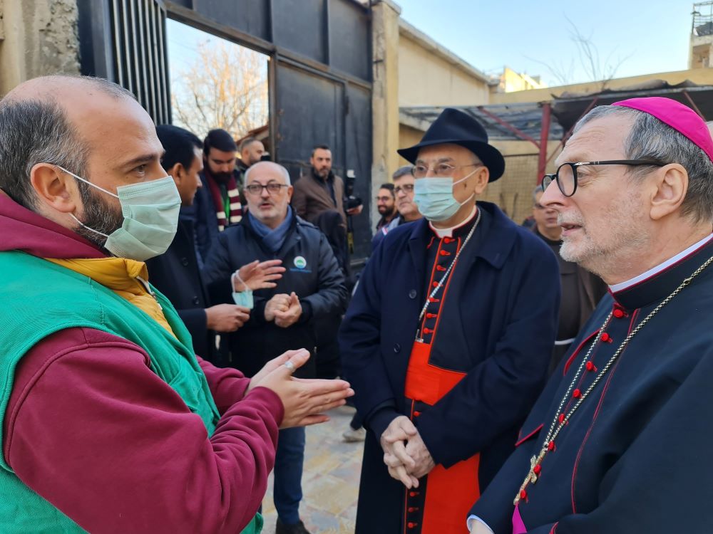 Archbishop Claudio Gugerotti and Cardinal Mario Zenari meet an aid worker in Aleppo, Syria. 