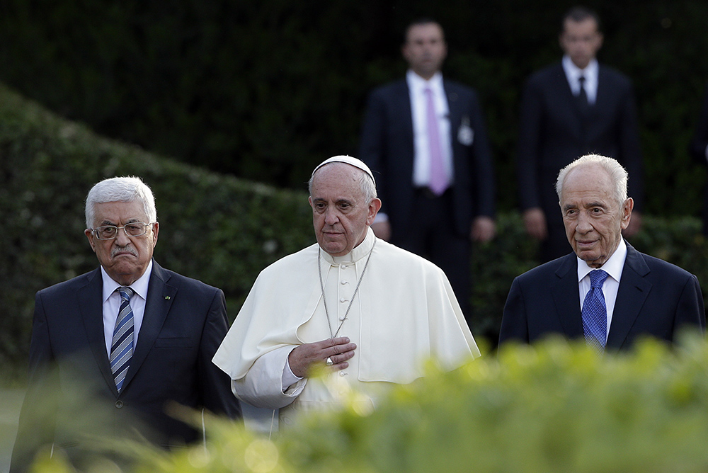 Pope Francis is flanked by Israel's President Shimon Peres, right, and Palestinian President Mahmoud Abbas during an evening of peace prayers in the Vatican gardens, Sunday, June 8, 2014. (AP Photo/Gregorio Borgia, File)