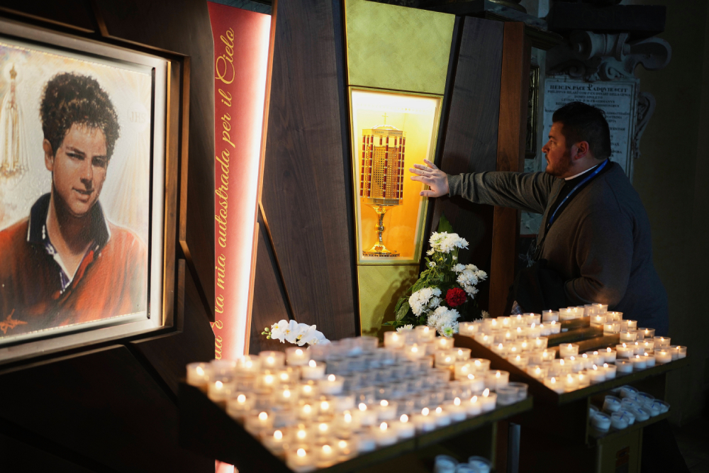 Father Cristopher Pujol prays at the heart relic of Carlo Acutis, the 15-year-old Italian boy who died in 2006 of leukemia and beatified in 2020, at the San Rufino Cathedral in Assisi, Italy, Wednesday, April 2, 2025.