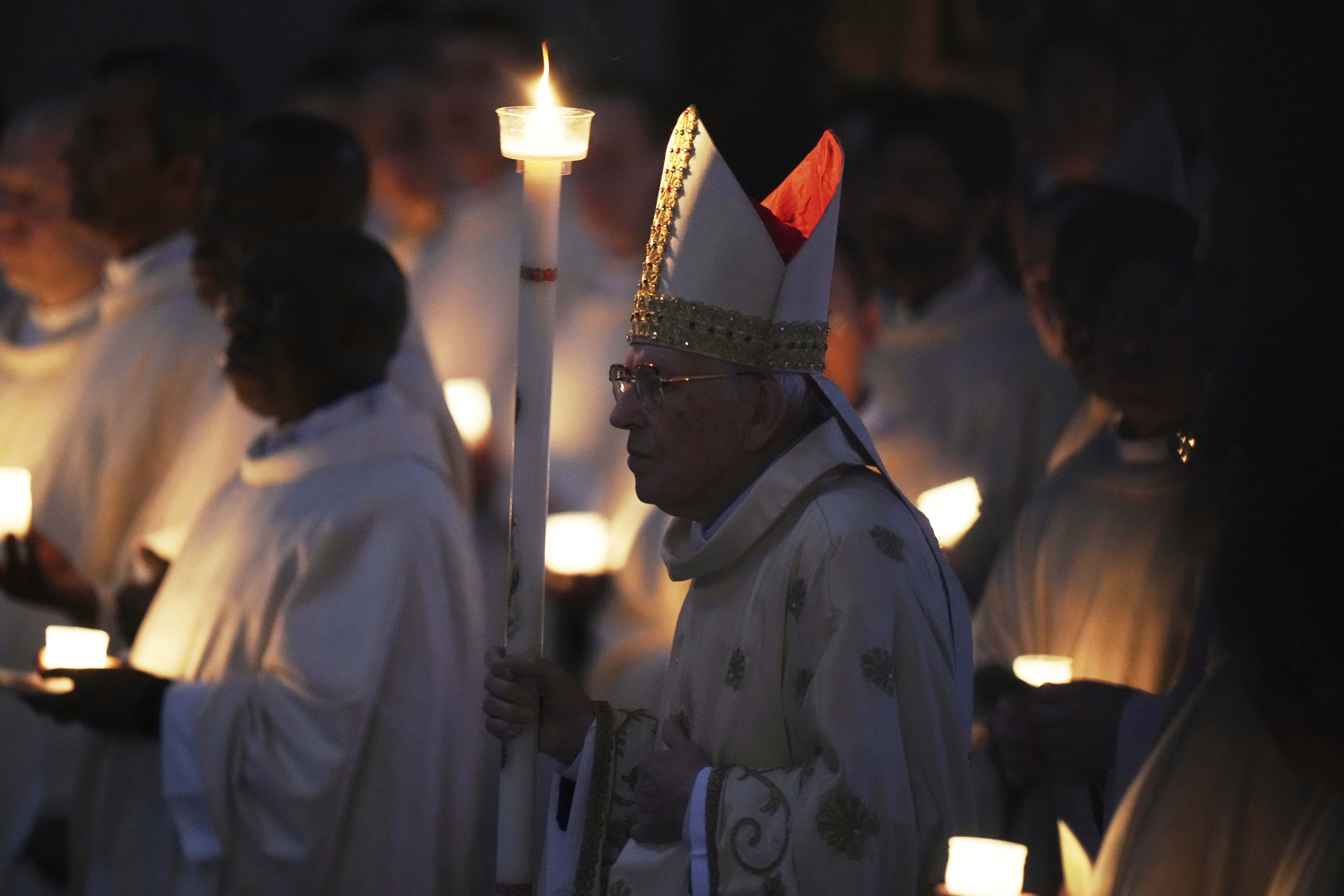 Dean of the College of Cardinals Giovanni Battista Re leads the Easter vigil inside St. Peter's Basilica at the Vatican, Saturday, April 19, 2025. (AP Photo/Alessandra Tarantino)