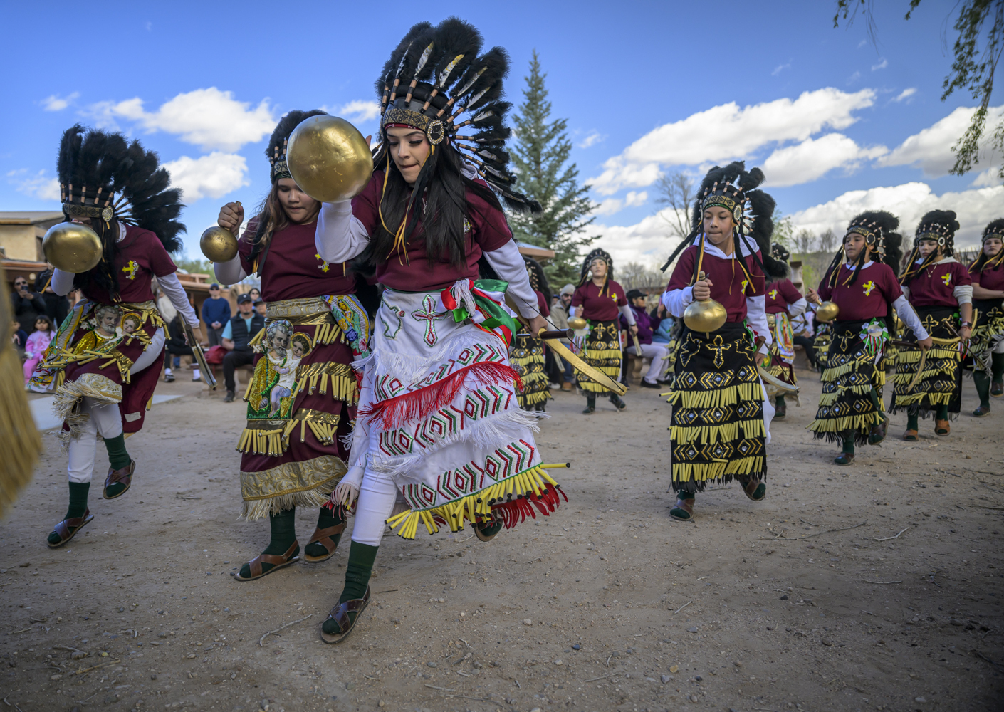 Members of the Danza Señor San Jose dance group perform behind El Santuario De Chimayo in Northern New Mexico during Holy Week on Good Friday, April 18, 2025. Chimayo, N.M. (AP Photo/Roberto E. Rosales)