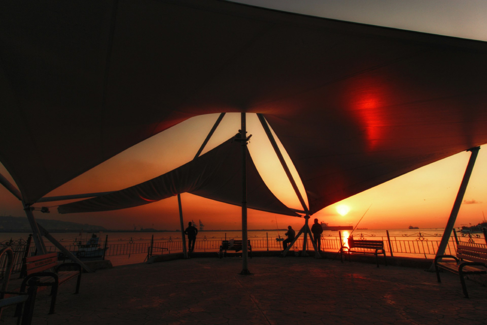 Geometric tent on a beach in Ereğli, Zonguldak, Turkey during a warm sunset.