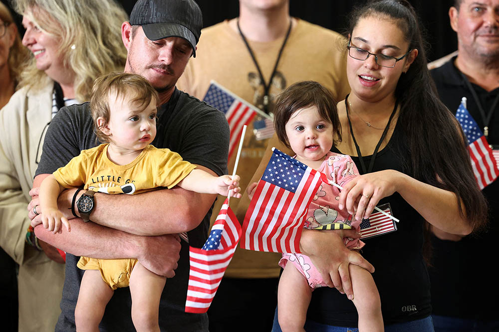 A family from the first group of white South Africans granted refugee status for being deemed victims of racial discrimination under U.S. President Trump's Refugee plan, attend a meet and greet event at Dulles International Airport in Virginia May 12, 2025. (OSV News/Reuters/Kevin Lamarque)