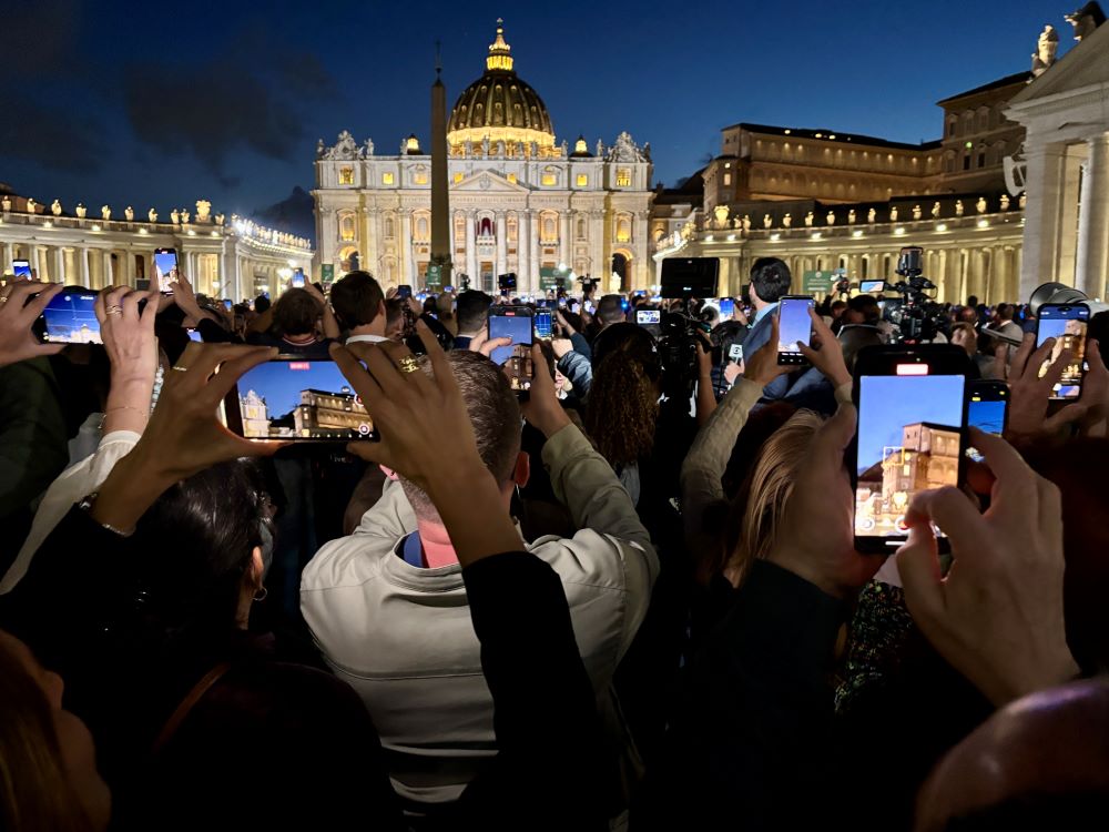 The crowd at St. Peter's Square takes photos of the black smoke from the Sistine Chapel on May 7. (NCR photo/James V. Grimaldi)