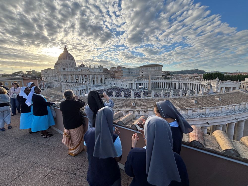 Nuns watch St. Peter's Square from nearby roof. 