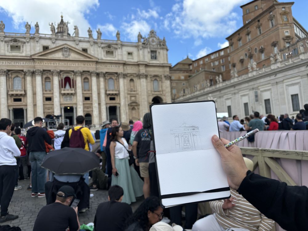 A young woman who stood alone among scattered crowds at St. Peter’s Square sketched St. Peter's Basilica 10 minutes before black smoke poured out of the chimney May 8. (NCR photo/Olivia Bardo)